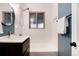 Bathroom featuring a sleek vanity, a bathtub, and modern finishes at 2415 Pontiac St, Denver, CO 80207