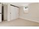 Cozy bedroom featuring neutral carpet, a window, and a closet with sliding doors at 2415 Pontiac St, Denver, CO 80207