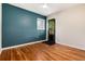 Bright bedroom with hardwood floors, ceiling fan, and access to the backyard at 2415 Pontiac St, Denver, CO 80207