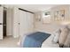 Cozy bedroom with sliding closet doors, neutral walls, and a comfortable bed with stylish pillows and blanket at 2415 Pontiac St, Denver, CO 80207