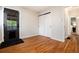 Bedroom featuring hardwood floors, closet with sliding doors, and access to hall at 2415 Pontiac St, Denver, CO 80207