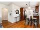 Cozy dining area featuring a glass table set and stylish decor, complemented by hardwood floors at 2415 Pontiac St, Denver, CO 80207