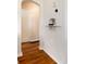 Hallway showcasing hardwood floors, arched doorway, and a decorative shelf with artistic accents at 2415 Pontiac St, Denver, CO 80207