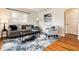 Relaxing living room featuring a plush sofa, an accent chair, and a contemporary area rug at 2415 Pontiac St, Denver, CO 80207