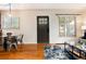 Open-concept living space with a dining area, a sleek coffee table, and hardwood flooring at 2415 Pontiac St, Denver, CO 80207
