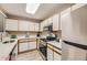 Well-lit kitchen with stainless steel appliances, white cabinets, and light countertops at 5745 W Atlantic Pl # 206, Lakewood, CO 80227