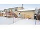 House exterior, deck, fence, and snowy backyard at 6094 S Dudley Way, Littleton, CO 80123