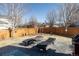 Inviting backyard featuring a concrete patio with lounge furniture, a wood fence, and mature trees at 9575 E 3Rd Pl, Denver, CO 80230