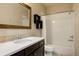 Well-lit bathroom with white subway tile shower, dark vanity, and modern fixtures creates a clean design at 9575 E 3Rd Pl, Denver, CO 80230