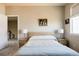 Well-lit bedroom with a minimalist aesthetic, featuring neutral tones and carpet flooring at 9575 E 3Rd Pl, Denver, CO 80230