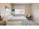 Comfortable bedroom with a bed, window, and chair, filled with natural light at 9575 E 3Rd Pl, Denver, CO 80230