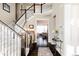 Elegant foyer with a grand staircase and dark hardwood floors at 9575 E 3Rd Pl, Denver, CO 80230