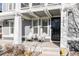 Cozy front porch with seating, offering a welcoming entrance to the home at 9575 E 3Rd Pl, Denver, CO 80230