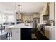 Well-equipped kitchen featuring a center island, stone backsplash, and stainless appliances at 9575 E 3Rd Pl, Denver, CO 80230