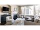 Cozy living room featuring a fireplace, comfortable seating, and lots of natural light at 9575 E 3Rd Pl, Denver, CO 80230