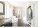 Luxurious main bathroom with a soaking tub, dual sinks, and a glass-enclosed shower at 9575 E 3Rd Pl, Denver, CO 80230