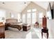 Bright and airy main bedroom with vaulted ceilings, large windows, and comfortable decor at 9575 E 3Rd Pl, Denver, CO 80230