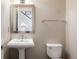 Well-lit powder room features a pedestal sink and modern fixtures at 9575 E 3Rd Pl, Denver, CO 80230