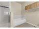 Bright bathroom featuring a tub and shower with modern tiled surround at 18061 E Saskatoon Pl, Parker, CO 80134