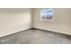 This bedroom features neutral walls, gray carpet, a window and base board trim at 18061 E Saskatoon Pl, Parker, CO 80134