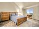 Cozy bedroom features a comfortable bed, complemented by warm lighting and a large window offering pleasant neighborhood views at 18061 E Saskatoon Pl, Parker, CO 80134