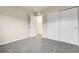 This bedroom features neutral walls, gray carpet and a closet with sliding doors at 18061 E Saskatoon Pl, Parker, CO 80134