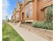Attractive townhomes with manicured landscaping, and a well-maintained sidewalk at 18061 E Saskatoon Pl, Parker, CO 80134