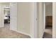 Neutral hallway with plush carpet leading to bedroom and study at 18061 E Saskatoon Pl, Parker, CO 80134