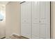 This hallway features a closet with bifold doors and gray carpet at 18061 E Saskatoon Pl, Parker, CO 80134