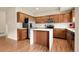 Bright kitchen with stainless appliances, center island and wood cabinets, perfect for cooking at 18061 E Saskatoon Pl, Parker, CO 80134