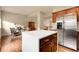 Open kitchen with large island, stainless steel refrigerator, and views to the living room at 18061 E Saskatoon Pl, Parker, CO 80134