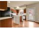 Modern kitchen features stainless steel appliances, island with white countertop, and wood cabinets at 18061 E Saskatoon Pl, Parker, CO 80134