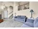Bright living area boasts a staircase, carpeted floors, and comfortable seating at 18061 E Saskatoon Pl, Parker, CO 80134