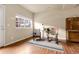 Cozy living room features rocking chairs, decorative rug, and a charming window view at 18061 E Saskatoon Pl, Parker, CO 80134
