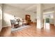 Spacious living room features hardwood floors, complemented by large windows and ample natural light, creating a welcoming ambiance at 18061 E Saskatoon Pl, Parker, CO 80134
