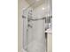 Modern tiled shower with glass door and built in shelves for organization at 18061 E Saskatoon Pl, Parker, CO 80134