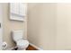 Bright powder room featuring a white toilet and storage cabinet with laminate flooring to enhance the room's appeal at 18061 E Saskatoon Pl, Parker, CO 80134