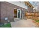 Brick patio area with sliding glass doors, offering a view of the home's interior at 8019 Wolff # G, Westminster, CO 80031