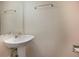 A clean half-bathroom with a modern sink and mirror, complemented by fresh paint at 8019 Wolff # G, Westminster, CO 80031
