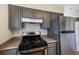 Modern kitchen with stainless steel appliances, grey cabinets, and ample countertop space at 8019 Wolff # G, Westminster, CO 80031