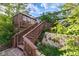 Multi-tiered back deck with stairs, landscaping, and outdoor seating areas at 9926 W Nova Pl, Littleton, CO 80127