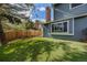 Backyard with artificial turf, bench and a fence, ideal for Gathering and pets at 9926 W Nova Pl, Littleton, CO 80127