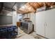 Basement laundry area with washer, dryer, shelving, cabinet and storage space at 9926 W Nova Pl, Littleton, CO 80127