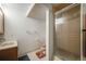 Full basement bathroom featuring a shower stall, tile flooring and an oak vanity at 9926 W Nova Pl, Littleton, CO 80127