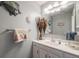 Bathroom with a vanity, sink, large mirror, and decorative accents at 9926 W Nova Pl, Littleton, CO 80127