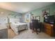 Bright bedroom features a large window, study area, and a comfortable bed, creating a cozy and functional space at 9926 W Nova Pl, Littleton, CO 80127