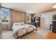 Bright bedroom with a large window, neutral carpet, white closet doors, and a view of the outdoors at 9926 W Nova Pl, Littleton, CO 80127