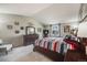 Bedroom with a vaulted ceiling, and a stylish decor featuring a large bed and framed artwork at 9926 W Nova Pl, Littleton, CO 80127