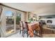 Cozy dining area with outdoor access, adjacent to the living room and fireplace at 9926 W Nova Pl, Littleton, CO 80127