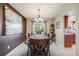 Elegant dining room with a wooden table, decorative lighting, and stylish decor, perfect for entertaining at 9926 W Nova Pl, Littleton, CO 80127